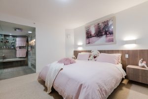 a fully renovated bedroom with custom made cabinets