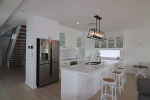 Glass door overhead cabinets in a classic white kitchen