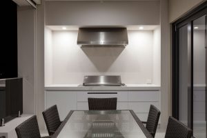 Custom white cabinet for integrated BBQ with stone benchtop