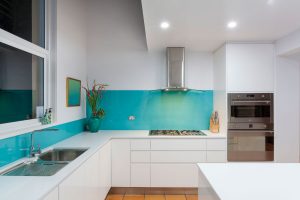 Kitchen - 2pac white cabinets - recessed handles - blue glass splashback - Gold Coast